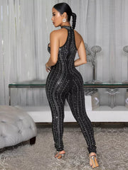 Black rhinestone halter neck romper with full length legs and allover sparkle detail.