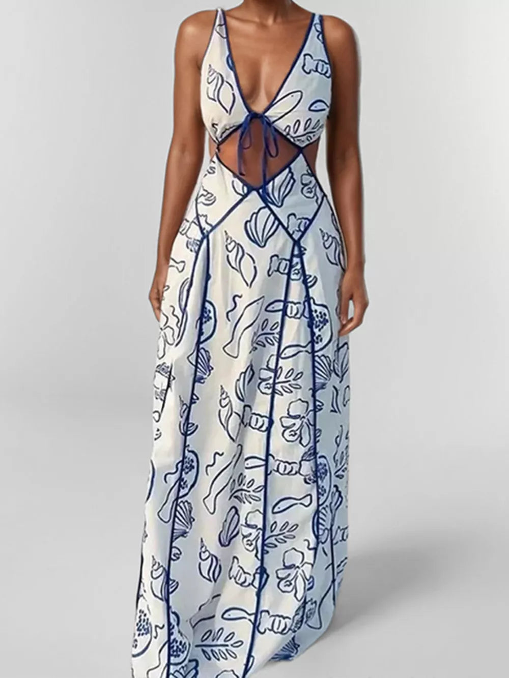 Blue and white oceanic print backless maxi dress with cutouts and a tie front.
