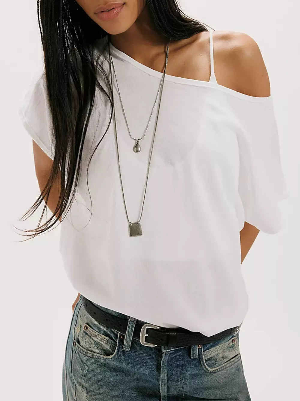 White asymmetrical relaxed fit t-shirt with a single strap and off-the-shoulder design.