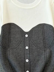 Color block knit t-shirt in white with gray bustier detail and white buttons.