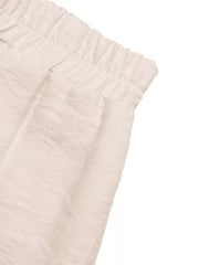 Boyshorts in apricot with elastic waist and textured fabric detail.