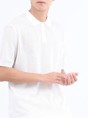 White textured knit polo shirt with classic collar and short sleeves.