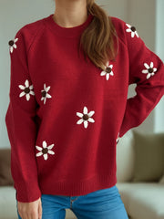 Burgundy knit sweater with embroidered white floral details and a crew neck.