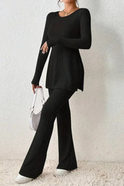 Black ribbed knit co-ord set with flared pants and side slit tunic.