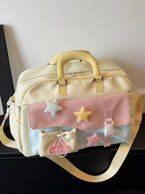 Chic color block travel bag with star embellishments and yellow handles.