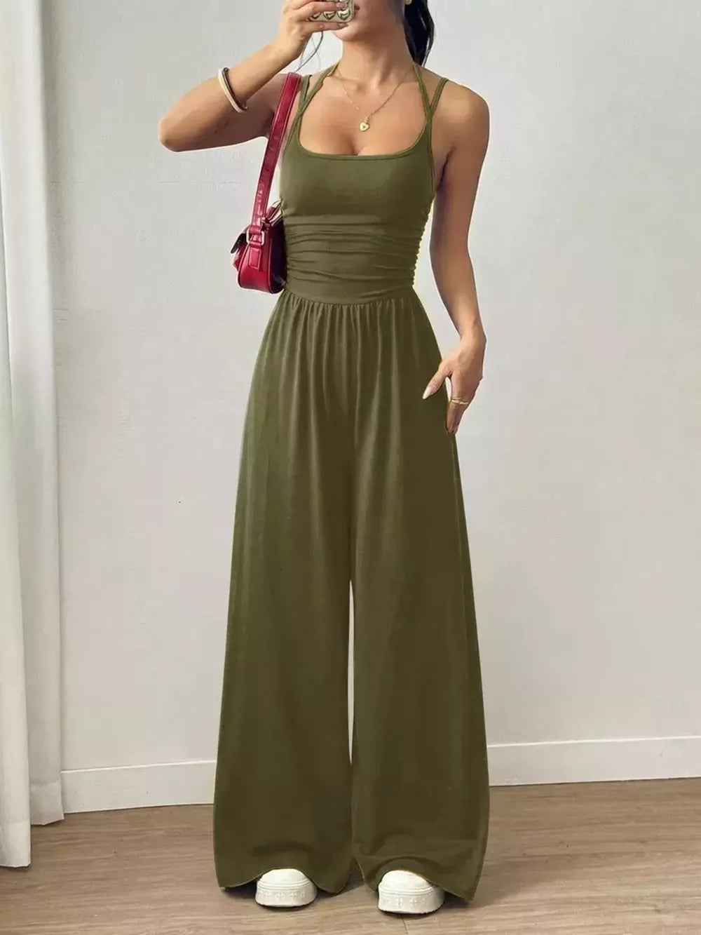 Army green ruched wide-leg jumpsuit with spaghetti straps and a square neckline.