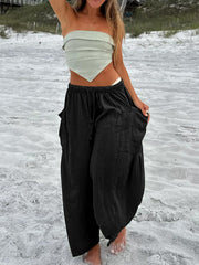 Black linen balloon trousers with cargo pockets and drawstring waist.