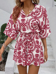 Deep Red printed tie-waist romper with button front and short sleeves.