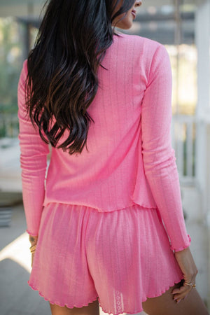 Fuchsia pink knit lounge set with lace trim and scalloped hem shorts.