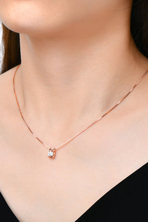 Rose gold necklace with a cubic zirconia prismatic cube pendant.