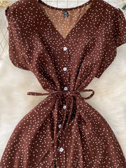Brown polka dot maxi dress with V-neck, short sleeves, button front, and belt.