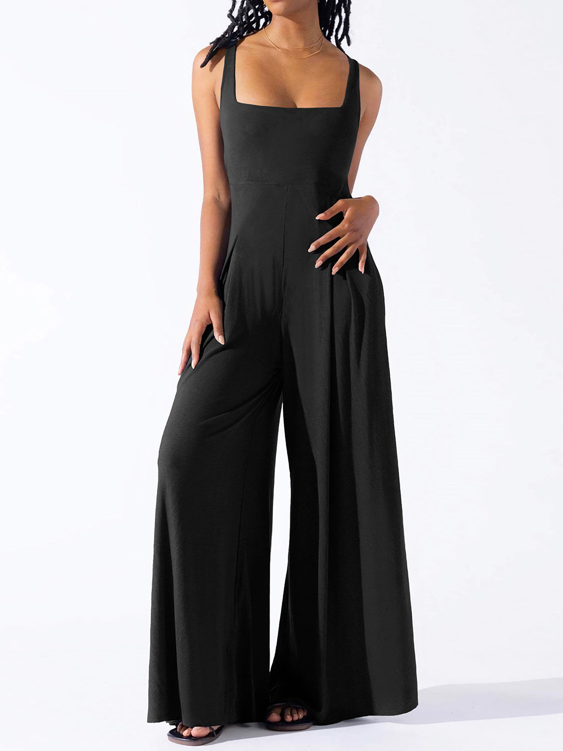 Black square neck palazzo jumpsuit with wide legs and pockets.