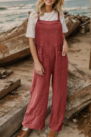 Textured cotton overalls in rust with square pockets and wide legs.