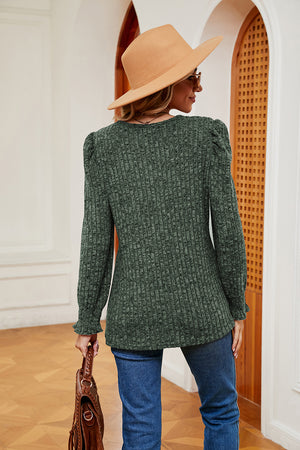 Textured knit blouse in Matcha Green with puffed sleeves and cuffed wrists.