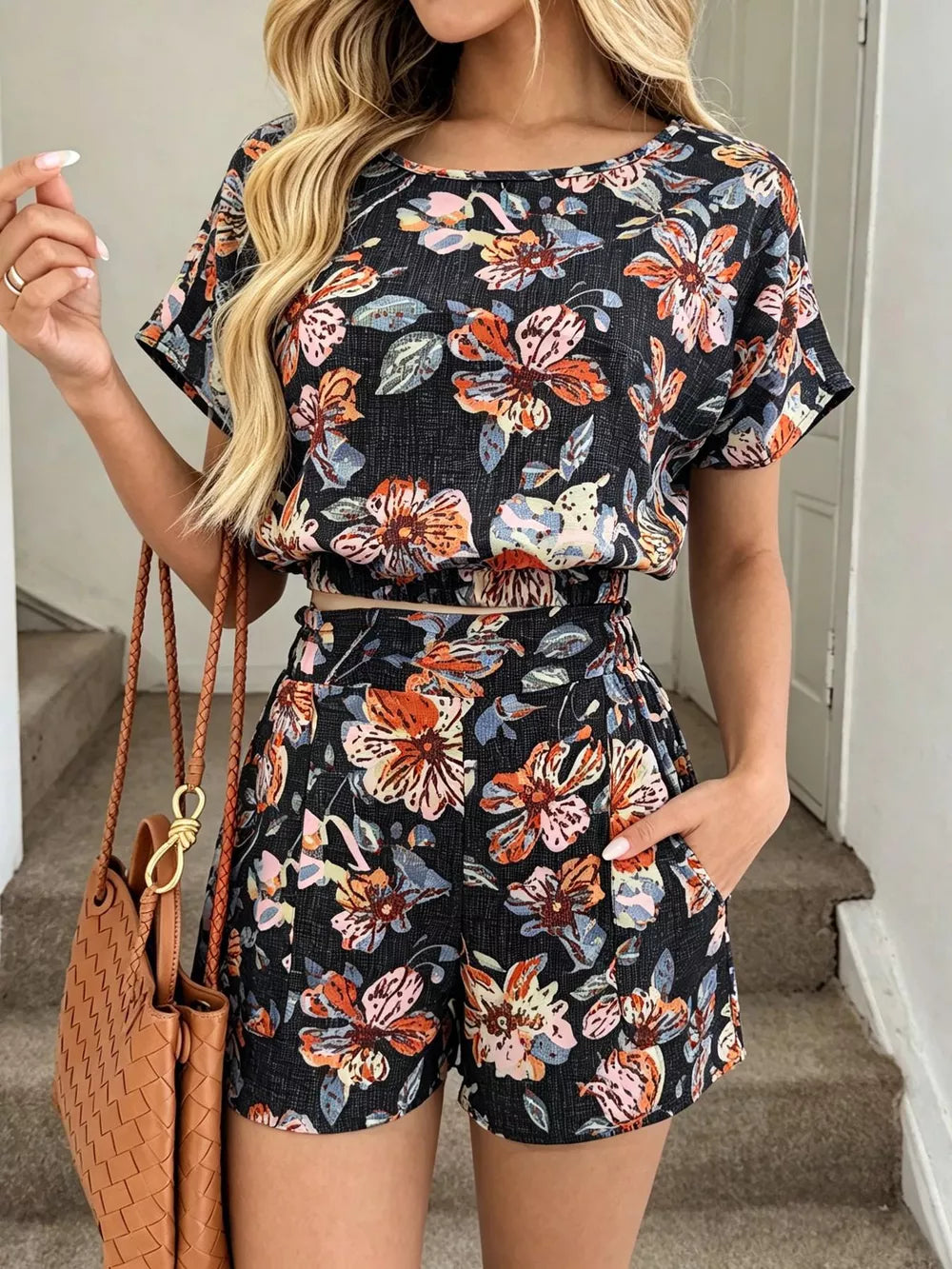 Floral two-piece set in navy blue with crop top and shorts, featuring pockets.