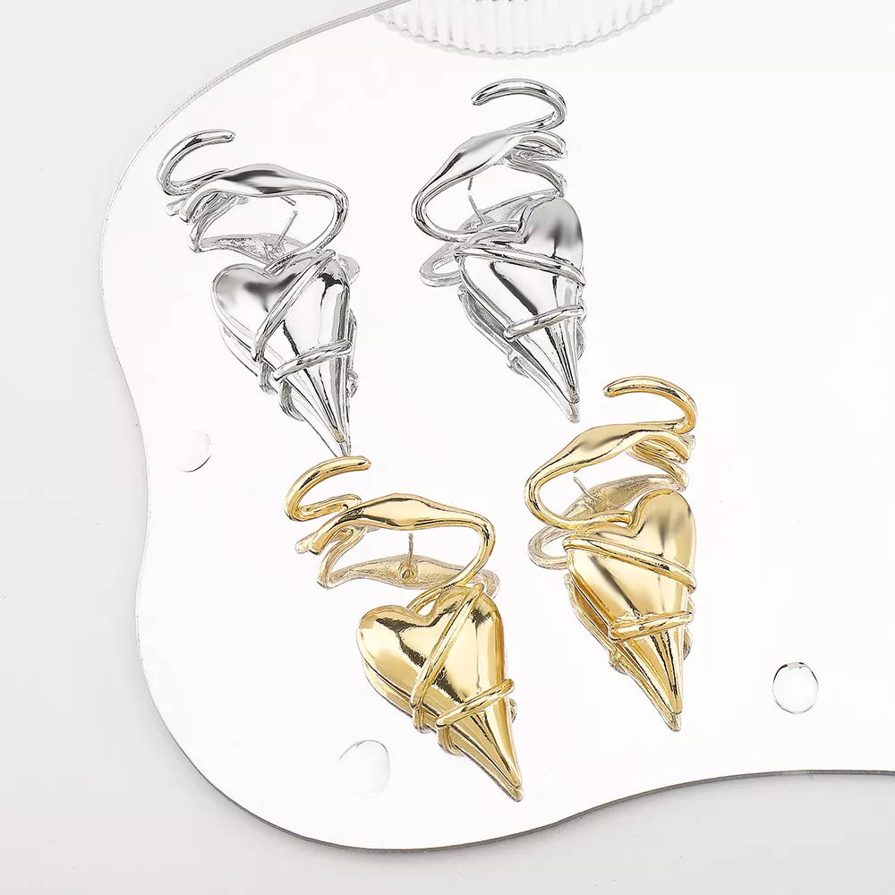 Twisted heart wire earrings in silver and gold luxe finish with unique sculptural detail.