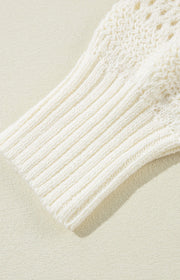 Cream openwork knit hoodie with ribbed sleeves and drawstring detail.