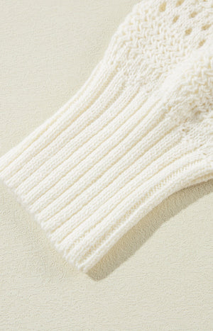 Cream openwork knit hoodie with ribbed sleeves and drawstring detail.