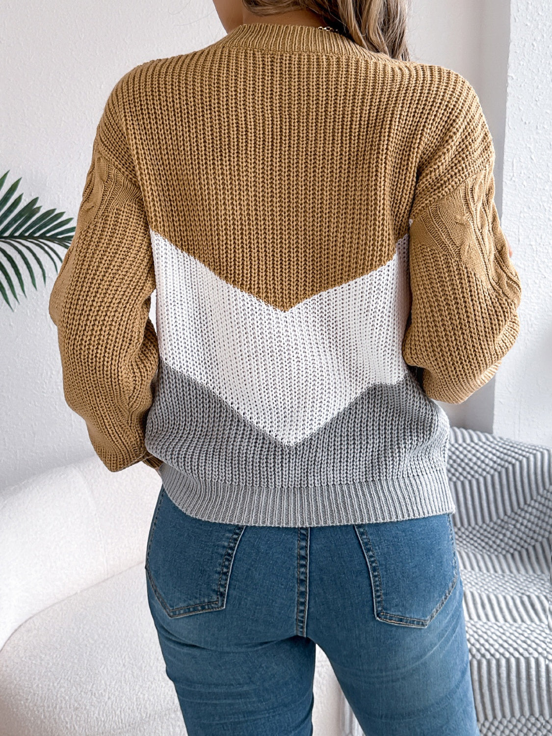 Chevron cable knit sweater in camel, white, and grey with cable knit sleeves.
