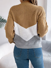 Chevron cable knit sweater in camel, white, and grey with cable knit sleeves.