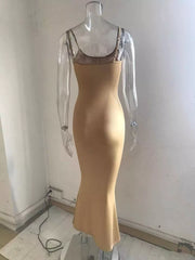 Camel spaghetti strap bodycon maxi dress with a mermaid hem.