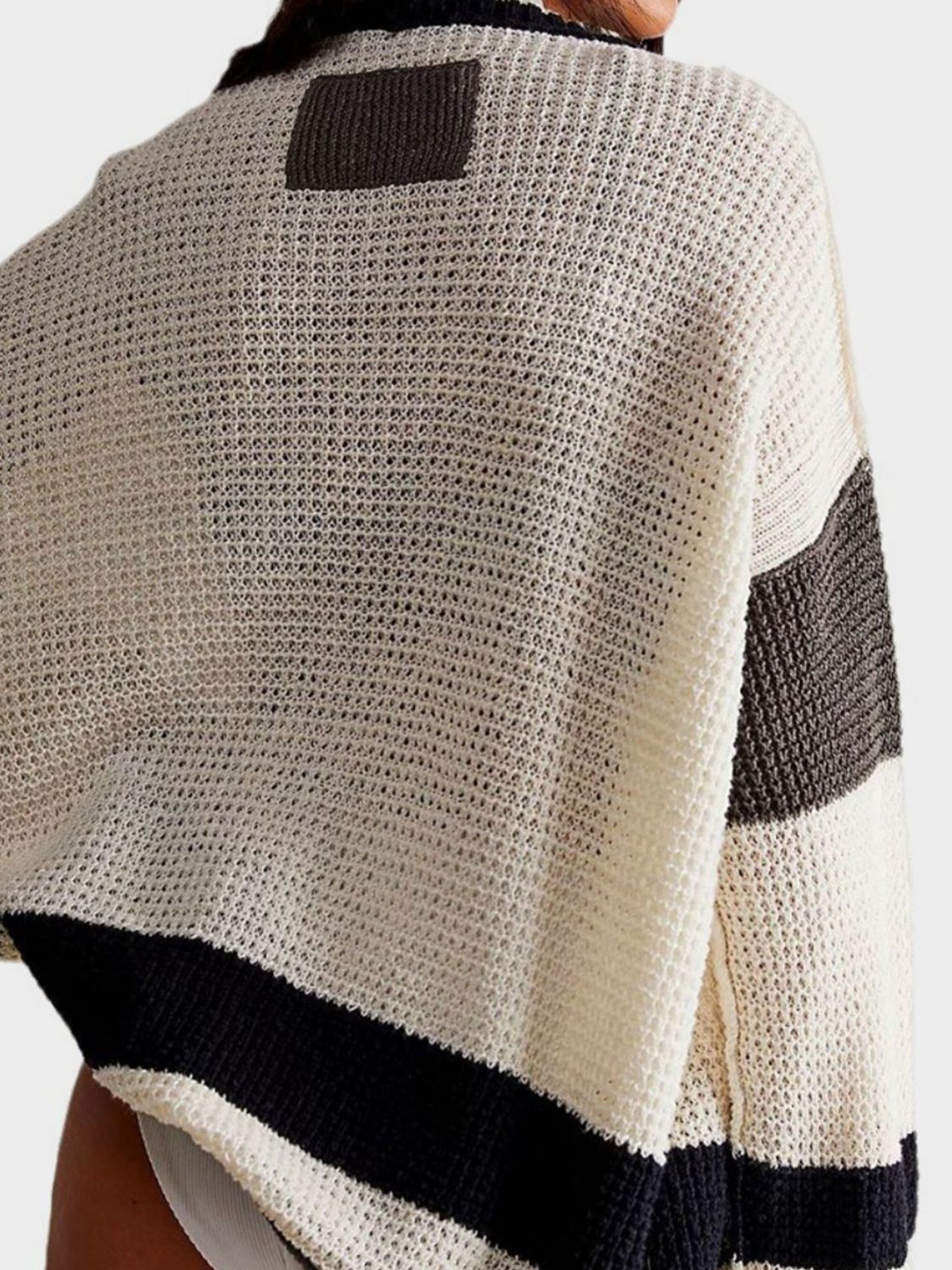 Textured knit cardigan with varsity stripes in cream, black, and dark grey.