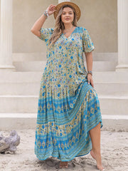 Bohemian floral maxi dress with tie waist, featuring a V-neck, short sleeves, and tiered skirt with blue border print.