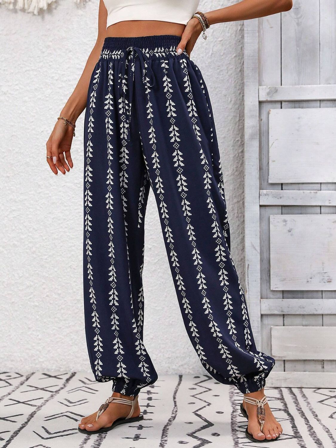 Dark Blue Indigo Leaf Print Gathered Ankle Trousers with drawstring waist and elastic cuffs.