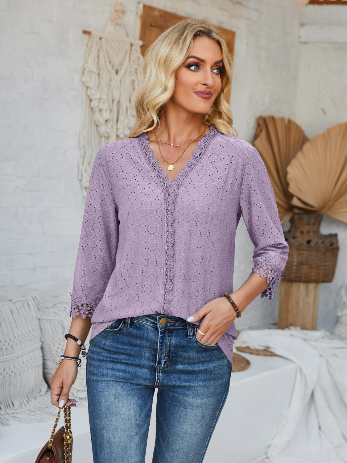 Lavender eyelet trimmed V-neck blouse with 3/4 sleeves and lace cuffs.