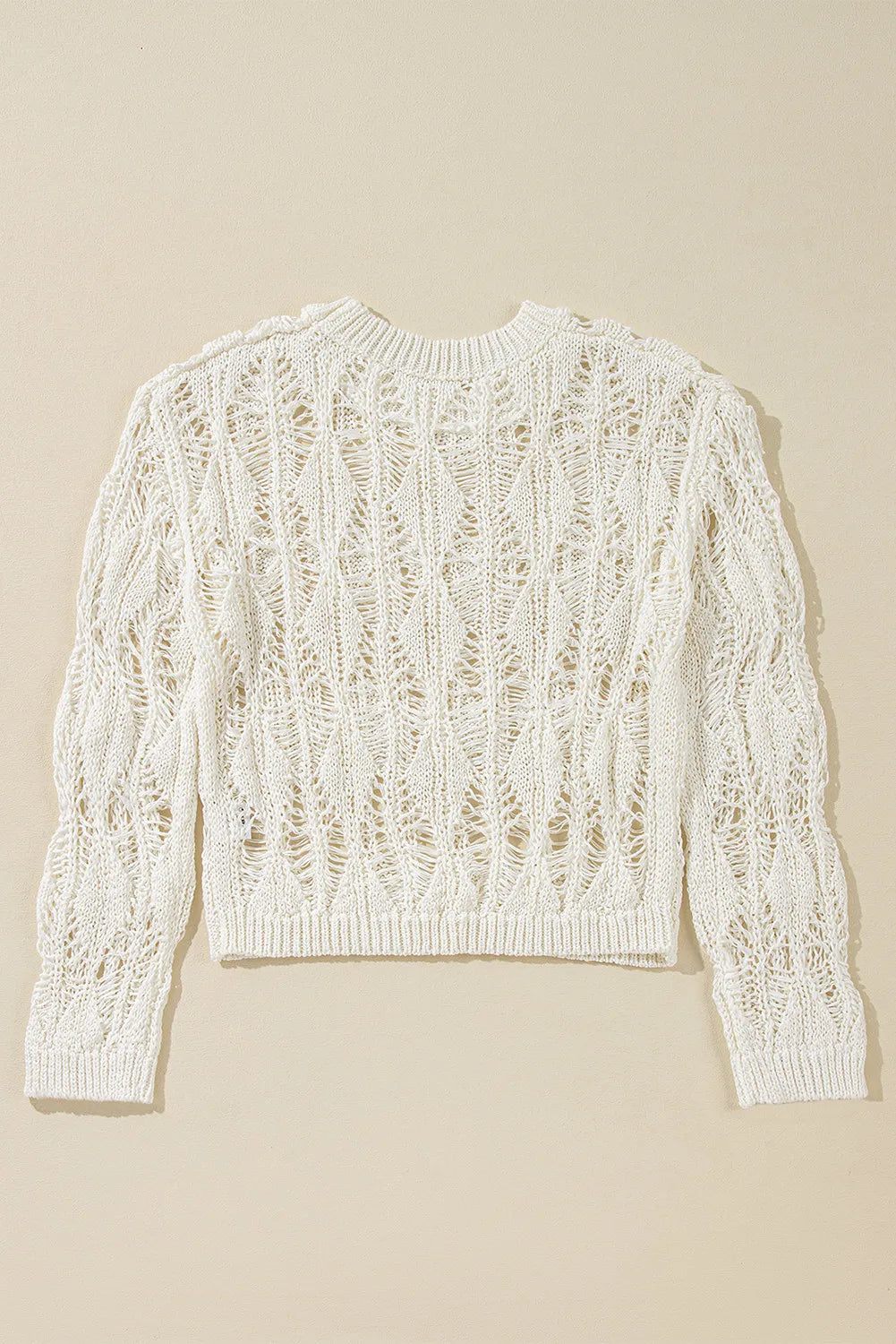 Ivory open-knit crochet crop sweater with a diamond pattern and crew neck.