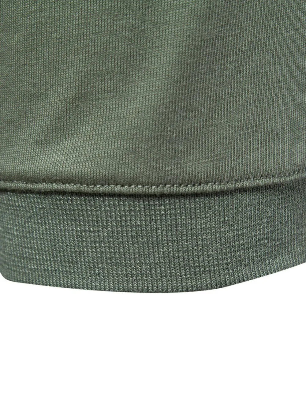 Tailored cotton polo in moss green, showing ribbed hem detail.