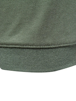Tailored cotton polo in moss green, showing ribbed hem detail.