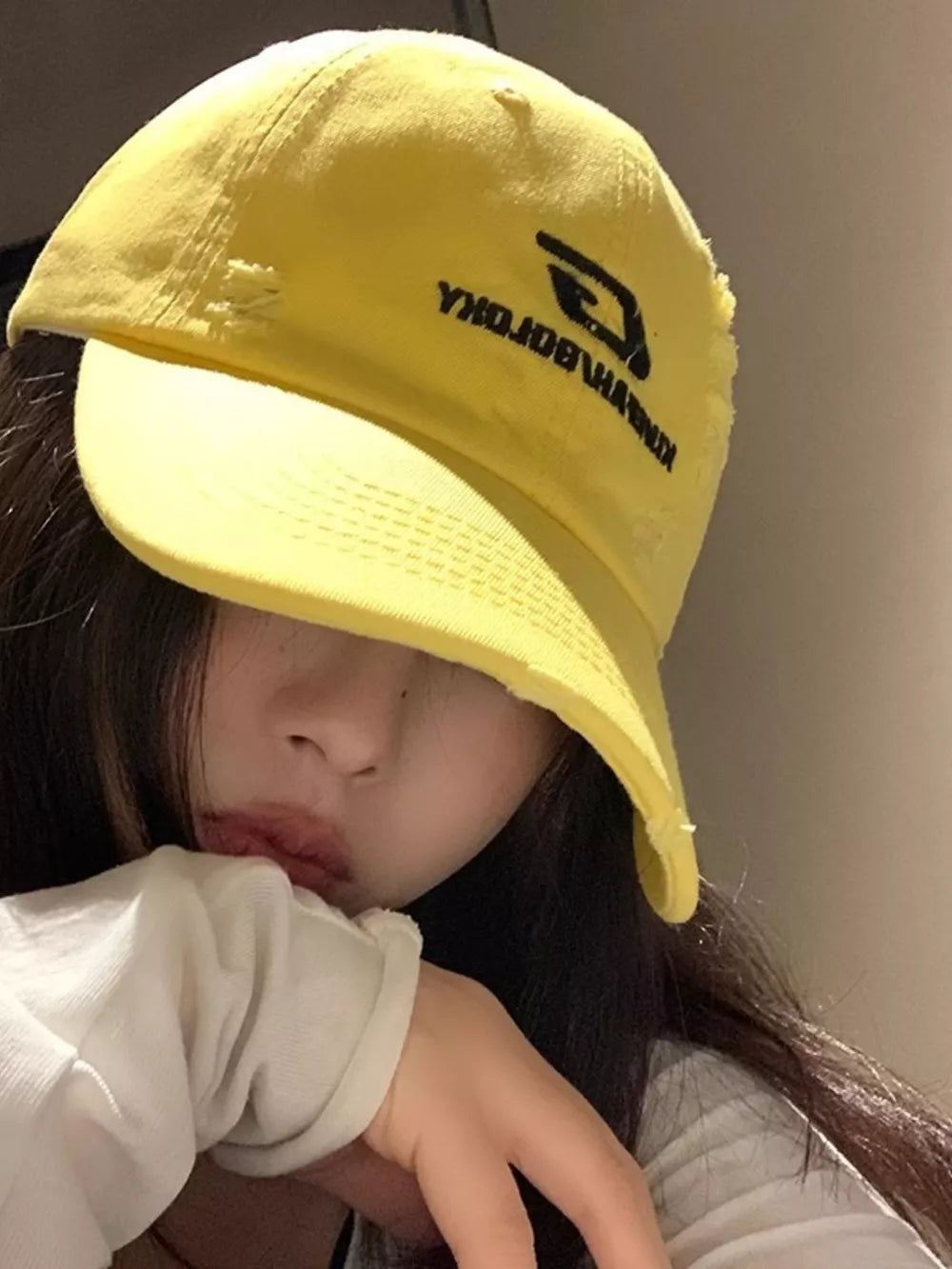 Yellow distressed baseball hat with embroidered logo detail