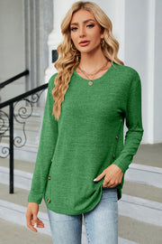 Green crew neck sweater with side button detail and slit hem