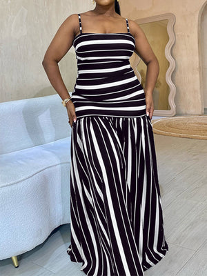 Plus size black and white striped maxi dress with spaghetti straps and a tiered skirt.