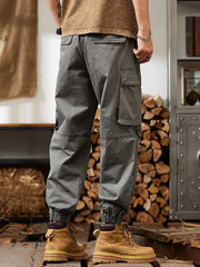 Grey relaxed fit cargo pants with multiple pockets and elastic cuffs.