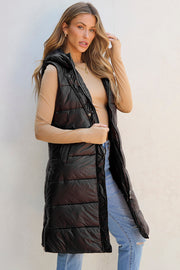 Longline black hooded puffer vest with zipper and snap closure, side pockets, and quilted detailing.