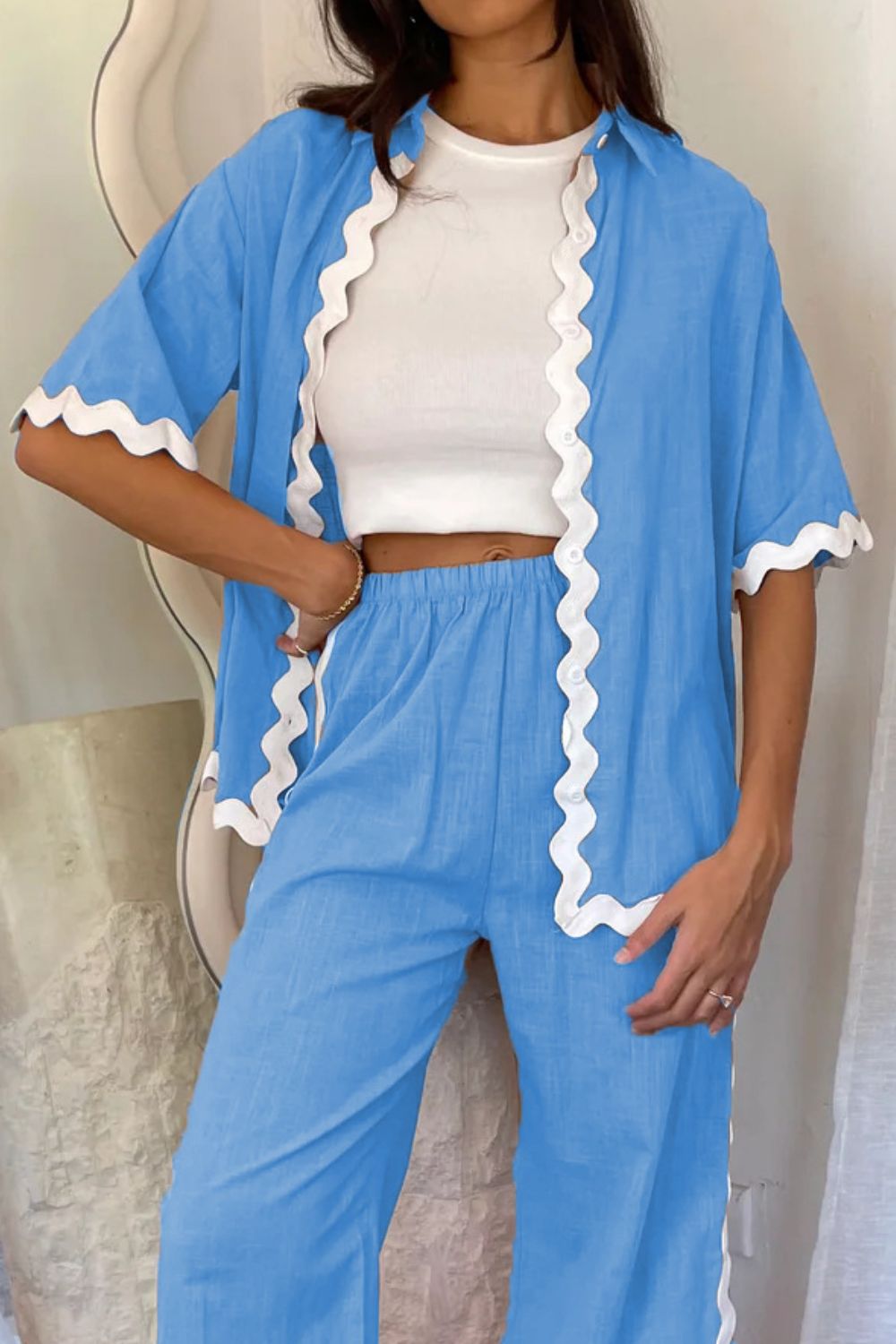 Sky blue co-ord set with scalloped trim shirt and pants, worn with white crop top.