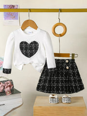 White baby girl's long sleeve top with plaid heart and matching plaid skirt.