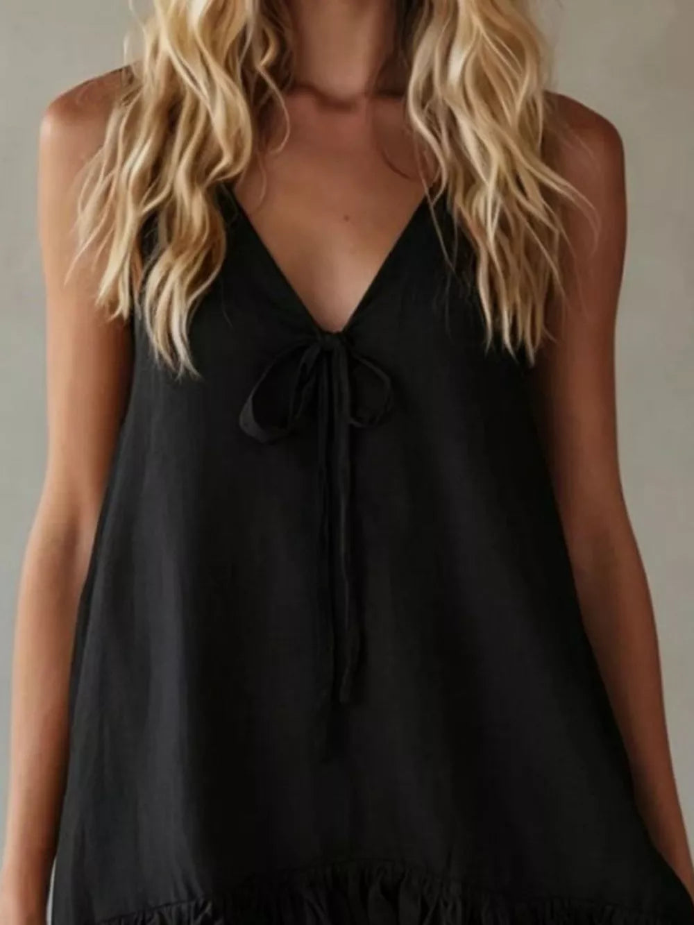 Black mini dress with V-neck tie front and ruffle hem