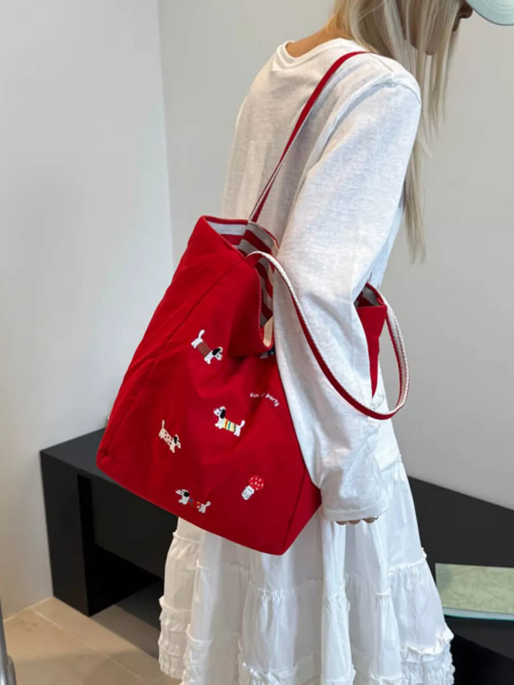 Red shoulder bag with dachshund embroidery and striped straps