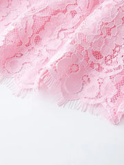 Pink lace midi dress detail with scalloped hem and fringe.