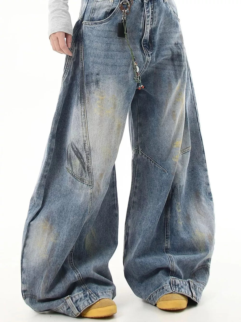Washed blue wide-leg jeans with pocket detail and distressed accents.