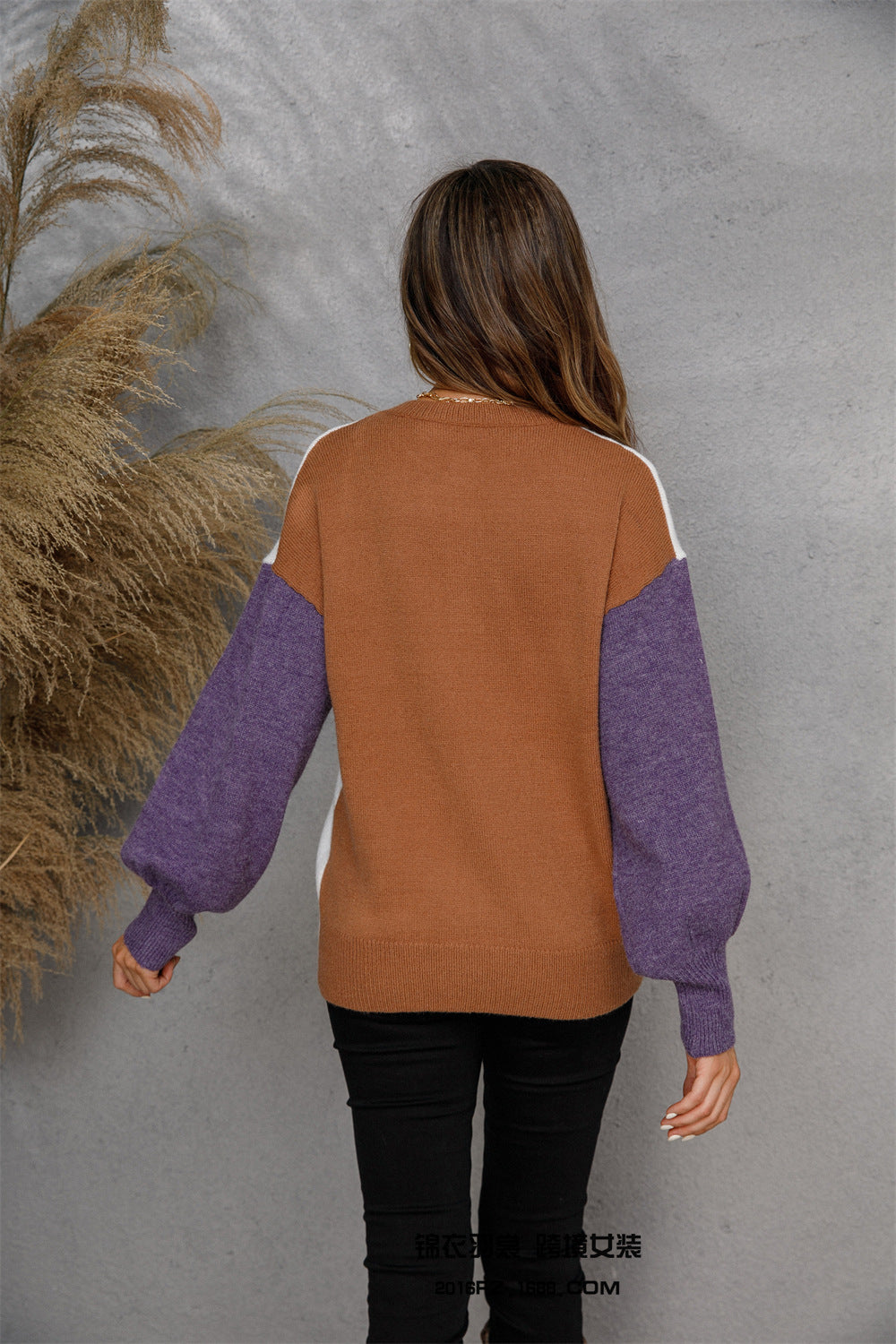 Colorblock knit sweater with brown body, purple sleeves, and white accents.