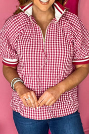 Red gingham cotton blend shirt with puff sleeves, zip neck, and contrast cuffs.