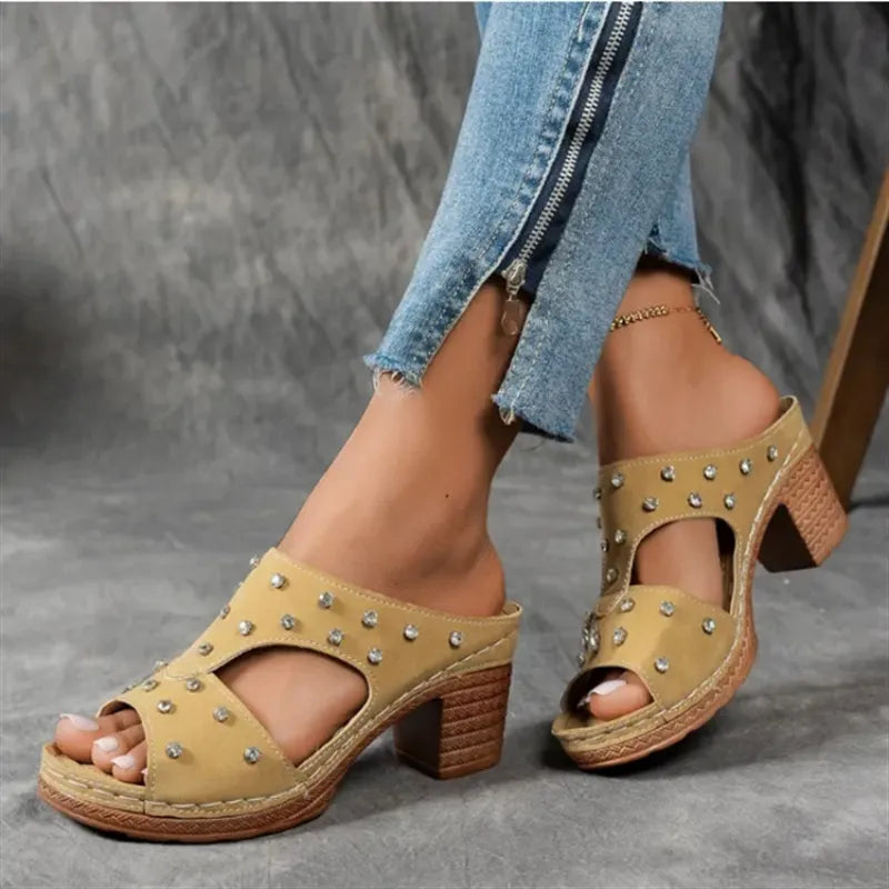 Tan studded cutout platform mule with open toe and block heel.