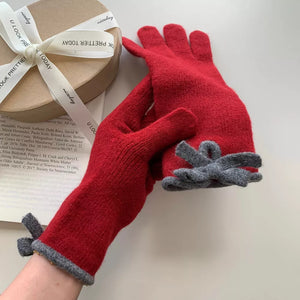 Deep red knit gloves with grey trim and bow detail