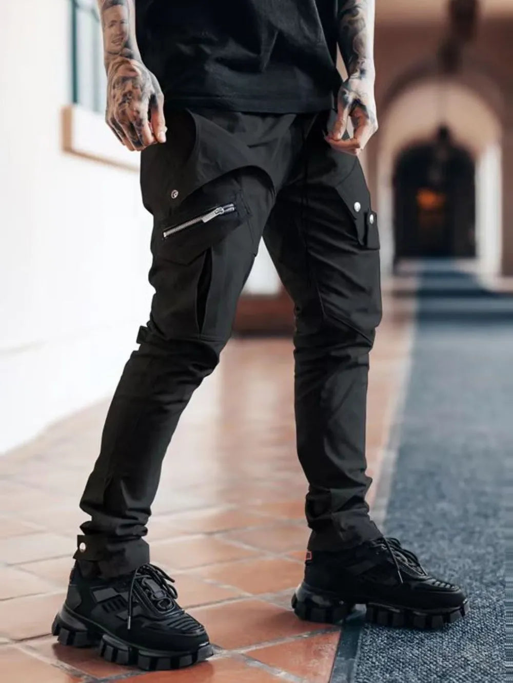 Black zip pocket slim cargo trousers with multiple functional pockets and a casual fit.