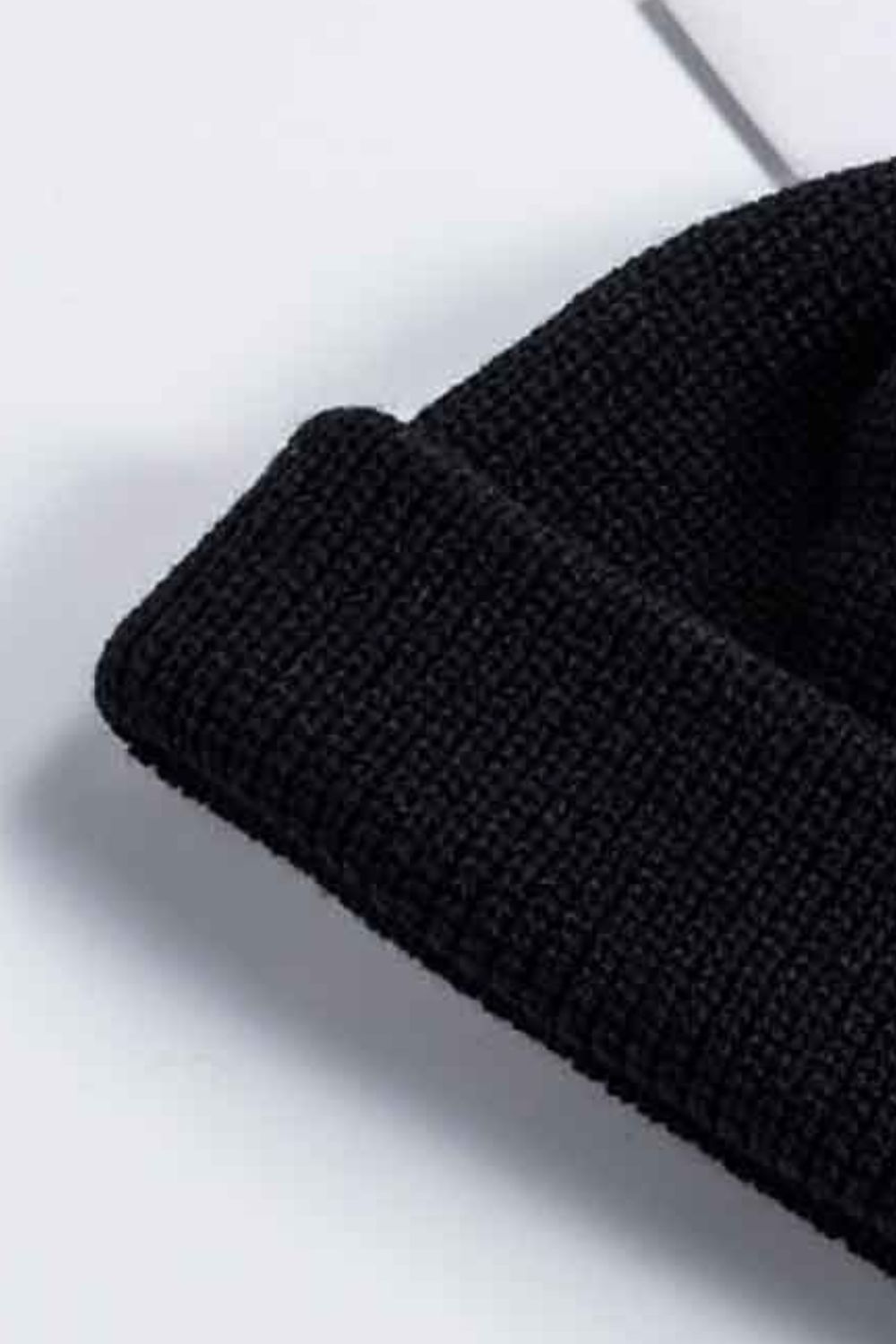 Black ribbed knit beanie with a turn-up cuff