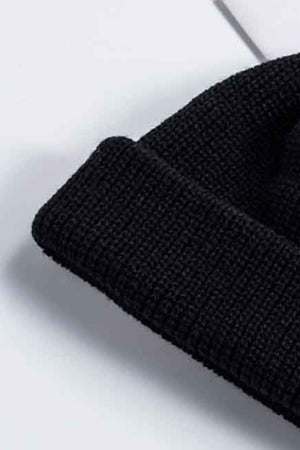 Black ribbed knit beanie with a turn-up cuff